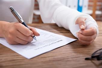 a person with a cast filling out a work injury compensation form a person with a cast filling out a work injury compensation form