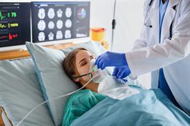 a woman in a hospital bed receiving oxygen