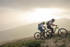 two mountain bikers on a hill