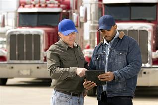 truckers reviewing a tablet