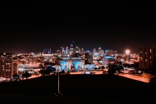 Picture of view of downtown KC and Union Station at night with lights.