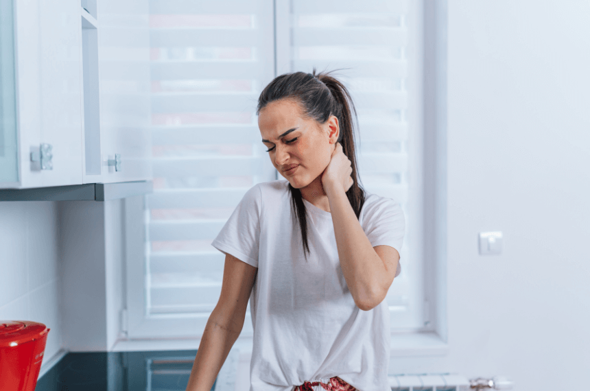 woman holding neck in pain