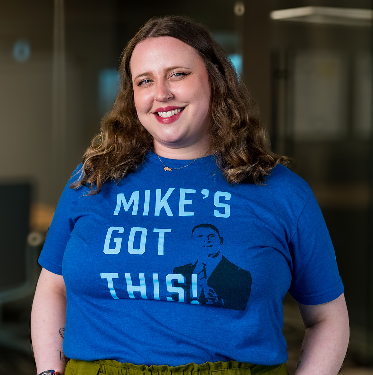 Brook Crowley wearing a blue Mike's Got This t-shirt