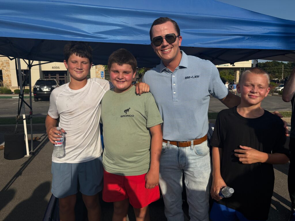 Attorney and kids at DM Law KU Kickoff