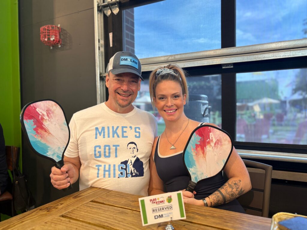 People holding pickleball paddles in KC