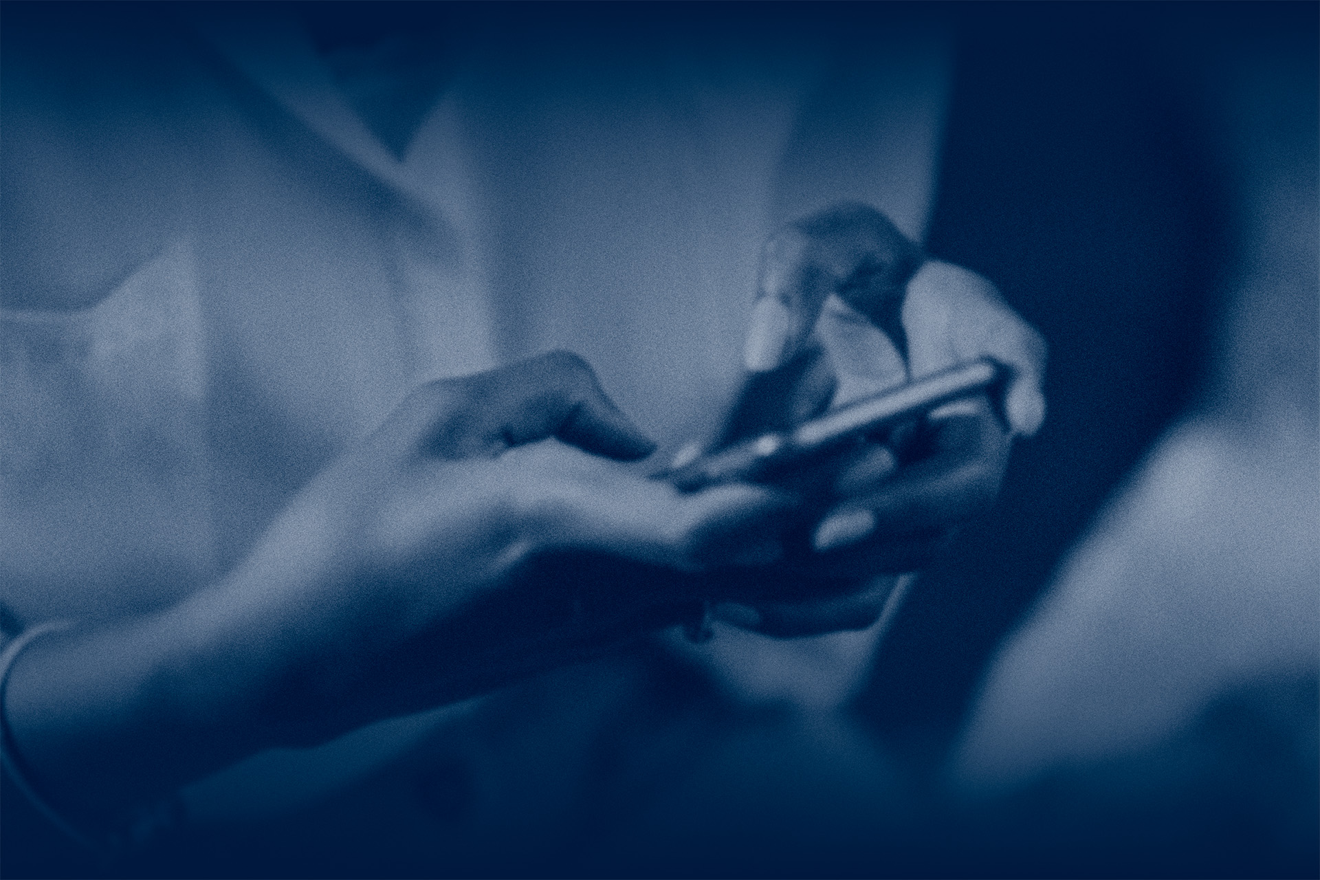 person holding a cell phone and typing with blue overlay
