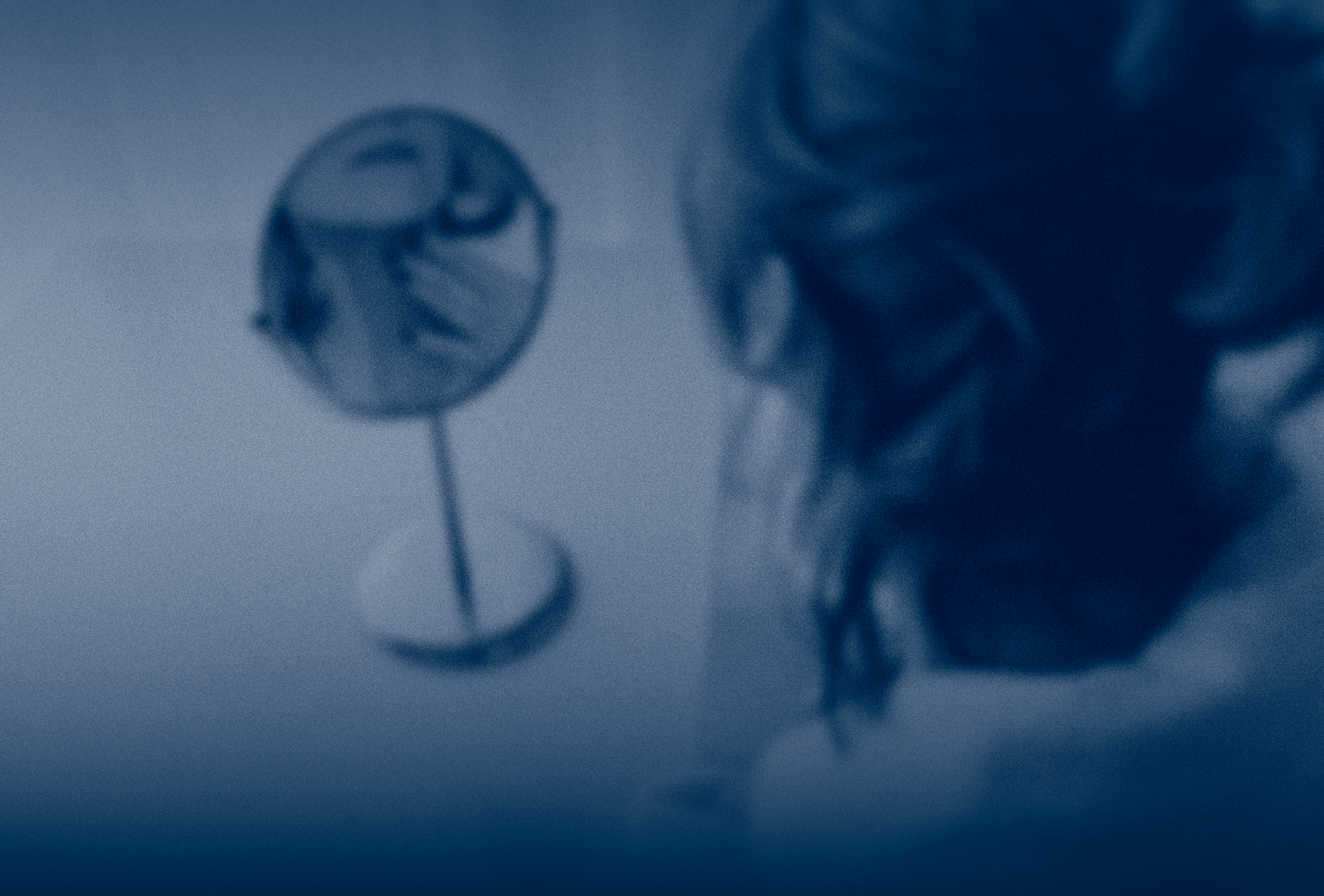 A woman looking into a small tabletop mirror, reflecting concern and the emotional impact of visible injuries such as dog bite scars.