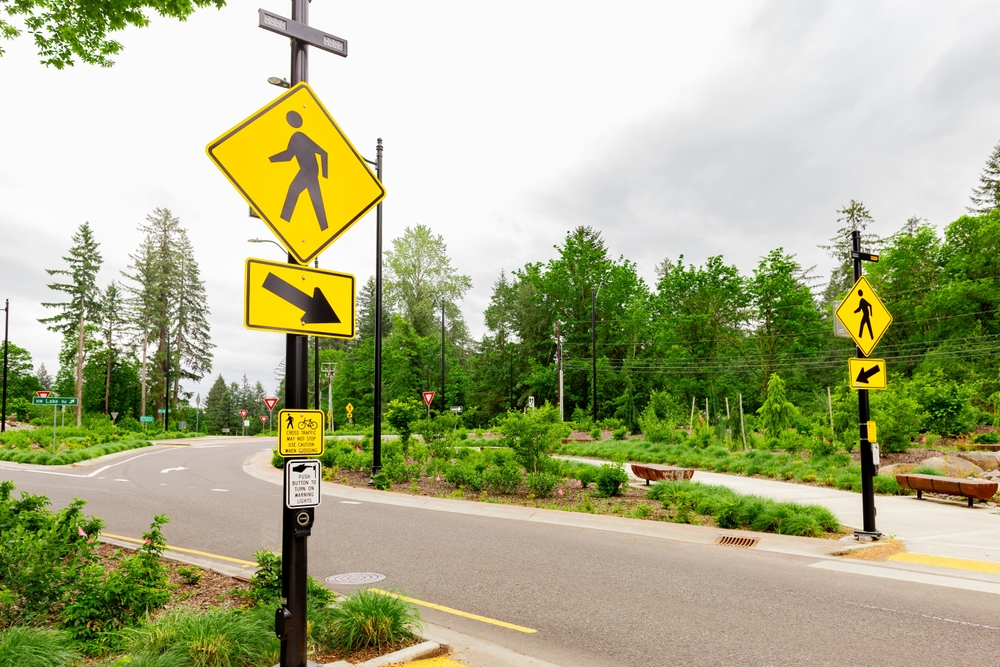 The Iconic Yellow Pedestrian Road Sign at a Local road in the Forest Area. Prioritizing the well-being of pedestrians, fostering a safer and more inclusive transportation environment.