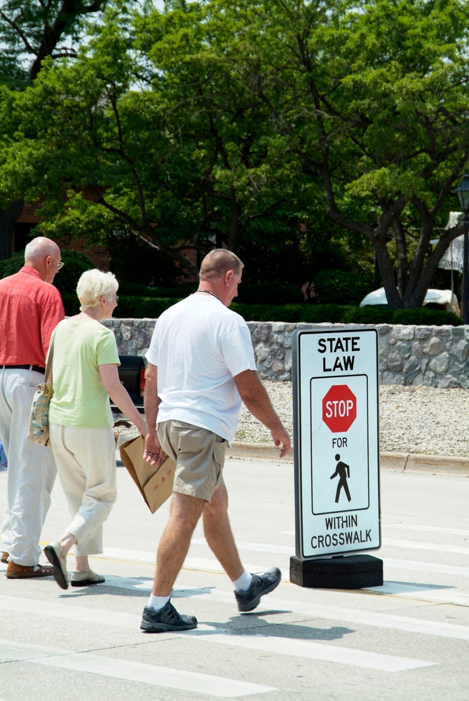 Stop sign in middle of street allowing pedestrians right of way when crossing road state law in Tampa, FL. Created 10.20.24